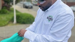 Expert professional in pest control putting gloves on to apply treatment to customer's home